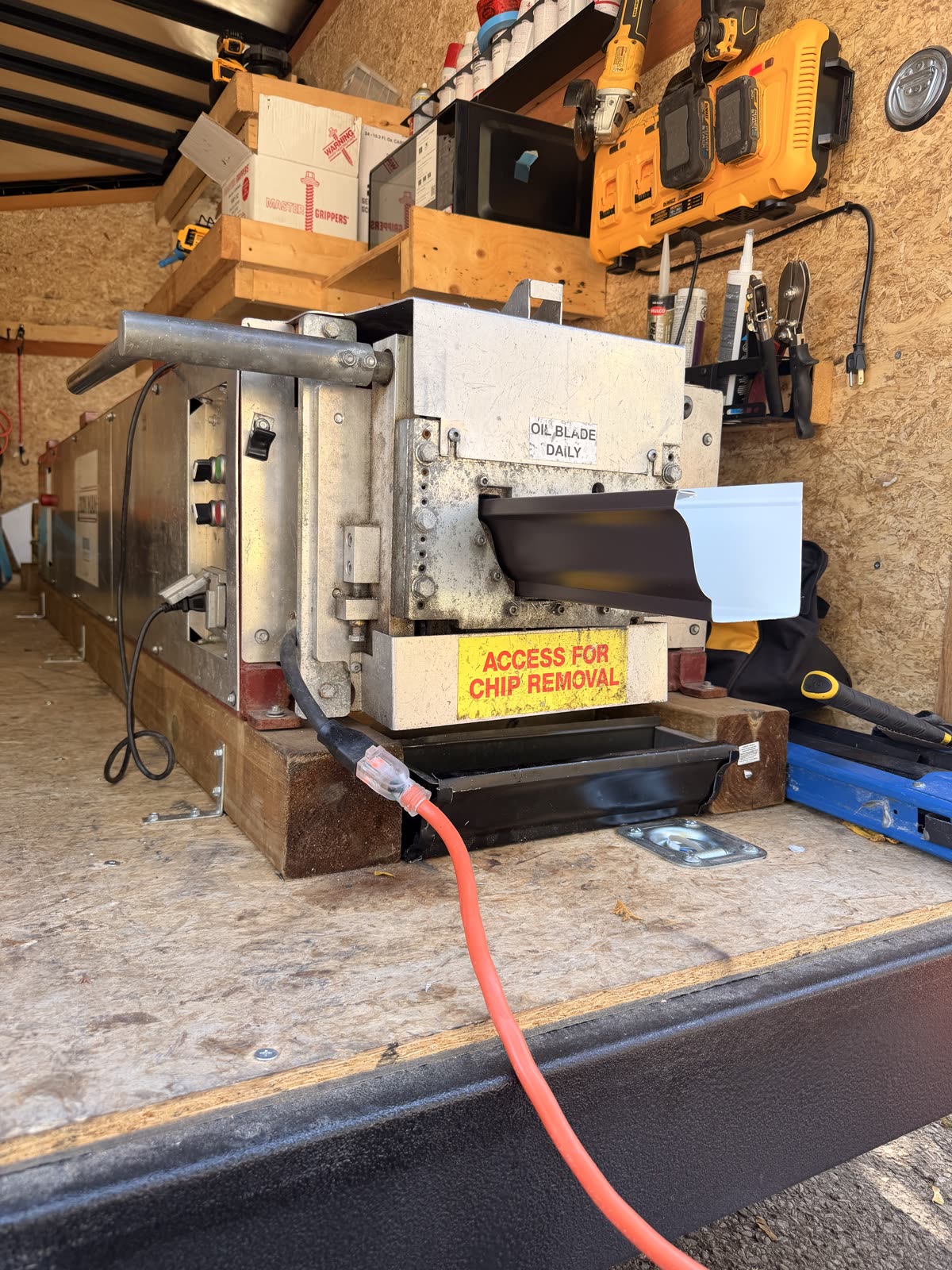 Seamless eavestrough coming out of the forming machine in the Forest City Eavestrough trailer, in the London, Ontario area