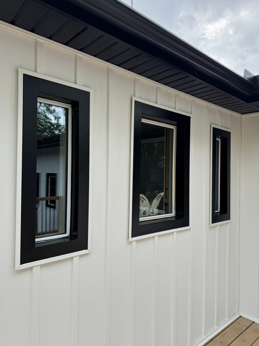 White Haven insulated board and batten siding with black window trim and black soffit